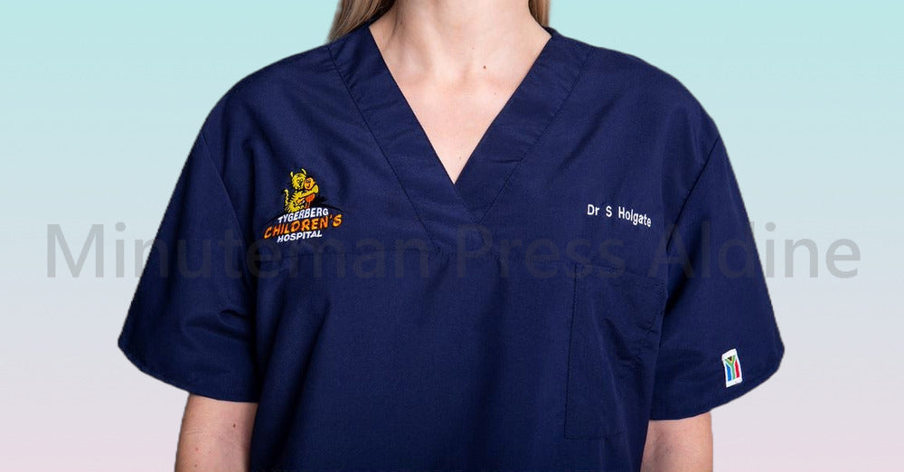 <img src=”Women-Embroidered-Scrubs-Minuteman-Press-Aldine” alt=”CUSTOM EMBROIDERED SCRUBS”>